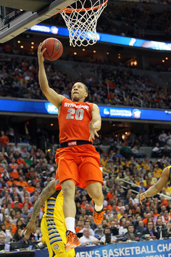 Brandon Triche #20 of the Syracuse Orange puts the ball up to the basket.