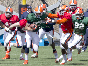 Syracuse running back George Morris III breaks a tackle in practice on Saturday. Morris has seen an expanded role this spring with the absence of Prince-Tyson Gulley.