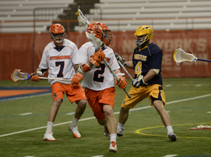 Derek Maltz (left) looks on as Kevin Rice cradles the ball behind the Canisius net in Friday's 17-5 demolition of the Golden Griffins. Maltz and Rice scored seven points total with Maltz bagging four goals.