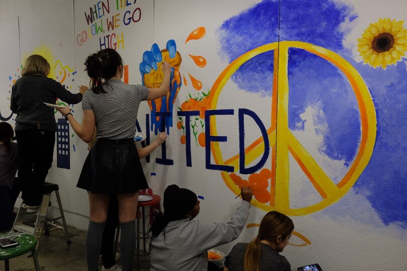 Students paint over racist graffiti found in art facility